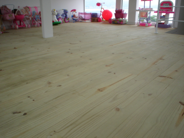 Acabamento refinado de assoalho de pinus tratado em projeto residencial